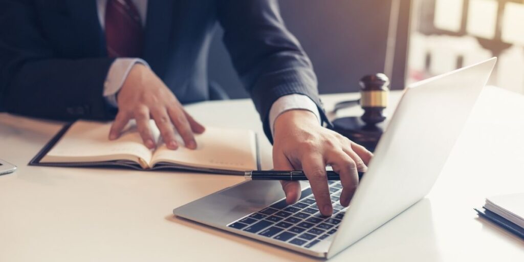 Lawyer using laptop for litigation information in law firms.