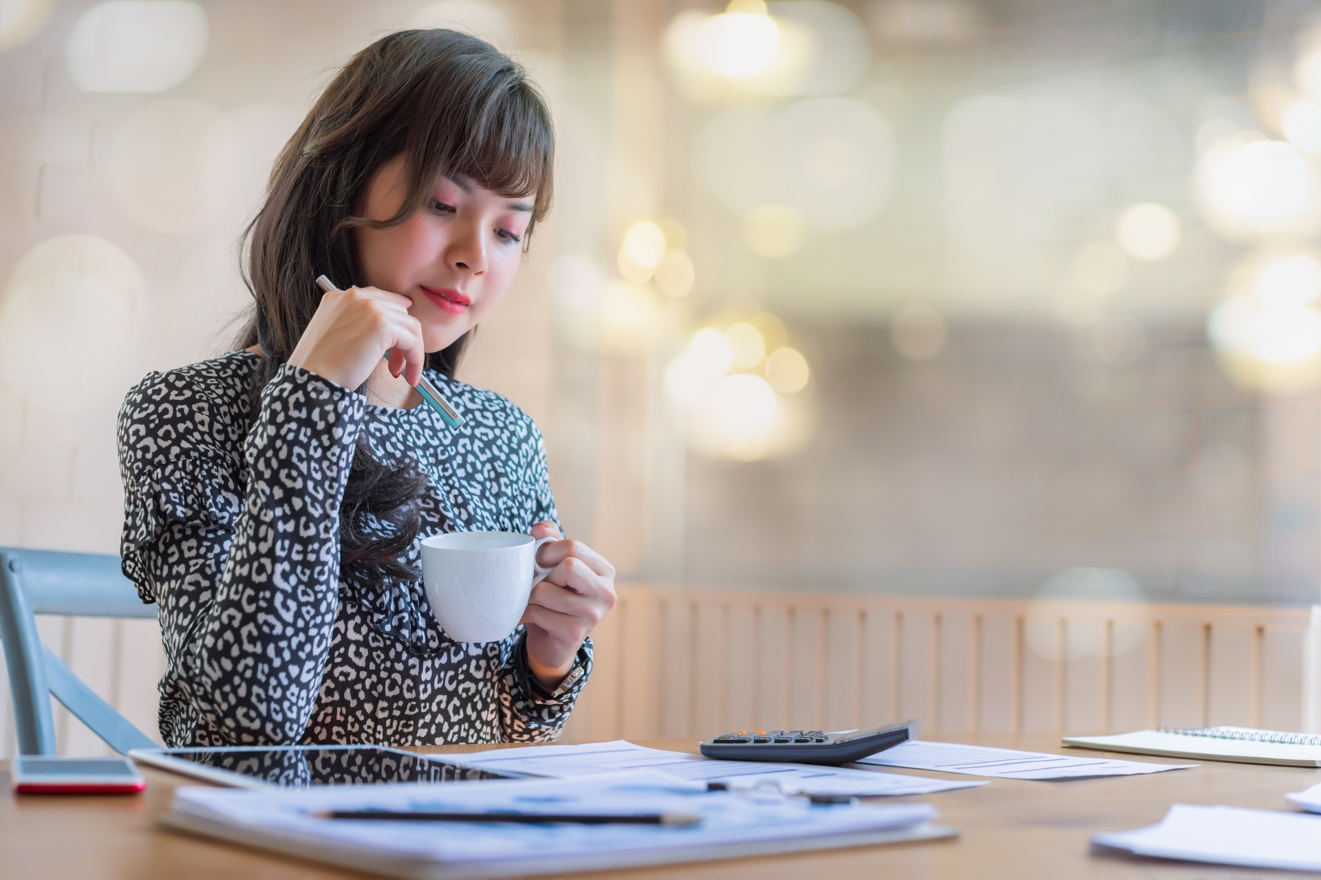 Happy beautiful asian accountant woman working about financial with business report and calculator.financial or accounting concept.